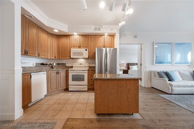Kitchen with white appliances, ornamental molding,
