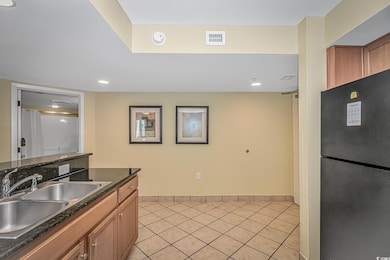 Kitchen with a sink, freestanding refrigerator, vi