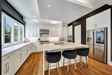 Kitchen featuring under cabinet range hood, white 