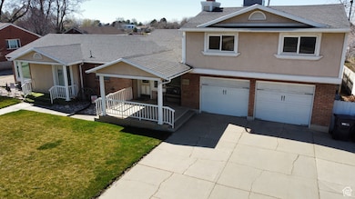 Traditional-style home with stucco siding, a porch, and brick siding
