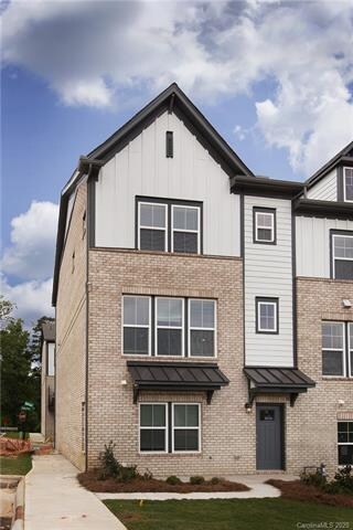 Charming entrance includes metal roof awnings with
