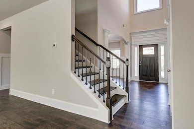 Entryway featuring stairway, arched walkways, a hi