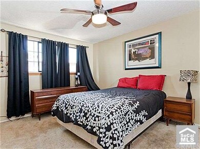 Large master bedroom with mirrored closet doors