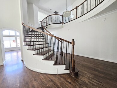 Staircase featuring a high ceiling and wood finished floors