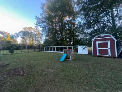 View of yard with a storage unit
