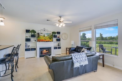 Living area with a lit fireplace, ornamental mold