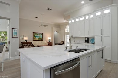 Kitchen featuring sink, dishwasher, an island with