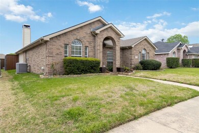 Ranch-style home with central AC and a front lawn