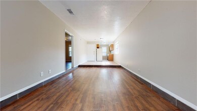 Empty room with dark hardwood / wood-style flooring