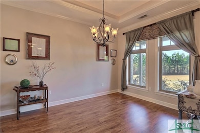 Formal Dining Room features 10' Tray Ceiling and b