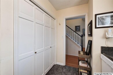 Double doors open to a stacked laundry closet and wonderful custom organizer pantry.