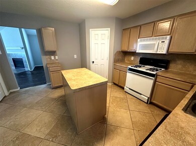 Tile flooring throughout kitchen and breakfast area.