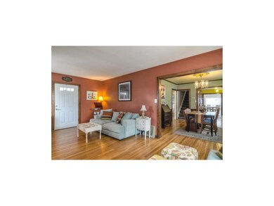 Living room with view into formal dining room