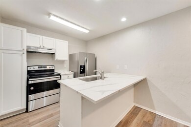 Kitchen with sink, stainless steel appliances, kit
