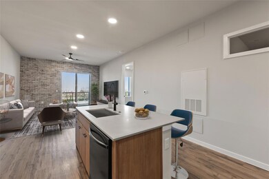 Kitchen featuring a sink, dishwashing machine, op