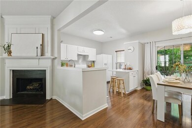Living area featuring dark wood-style floors, a fi