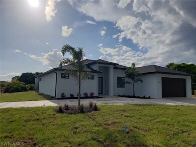 View of front of home featuring a garage and a front lawn