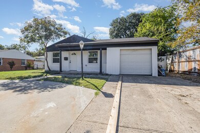View of front of home featuring concrete driveway, a porch, and a garage