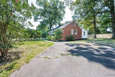 View of side of property with a lawn