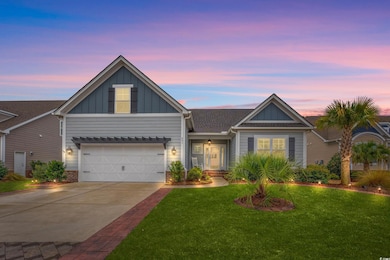 View of front of property featuring a yard and a g