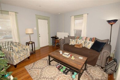 freshly painted living room with hardwood flooring
