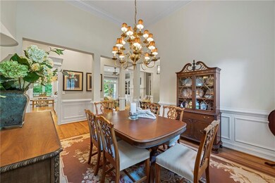 Dining area with light wood-style flooring, crown 