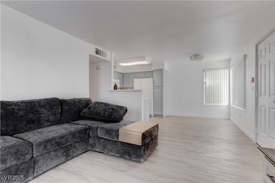 Living room with light wood-style floors and baseb