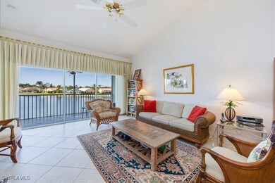 Tiled living room featuring a water view, high vau