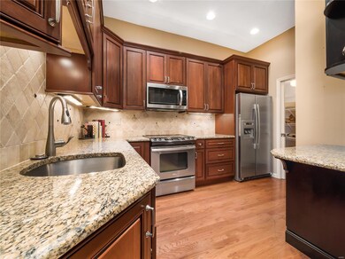 View of kitchen looking toward pantry closet. Large breakfast bar.