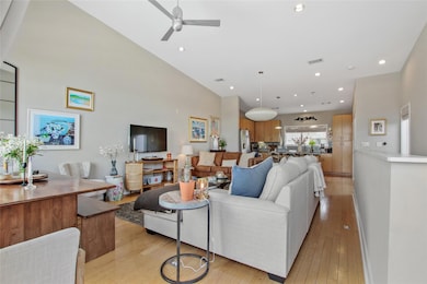 Living room featuring light wood-style flooring, recessed lighting, and a ceiling fan