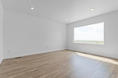 Unfurnished room featuring light wood finished floors, recessed lighting, and a textured ceiling