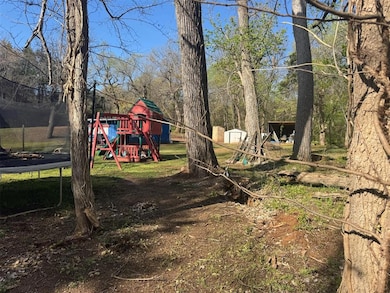 View of yard featuring an outdoor structure, a sto