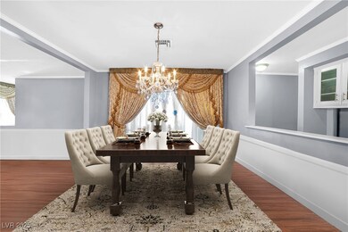 Dining space featuring a chandelier, crown molding