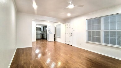 Unfurnished living room featuring crown molding, c