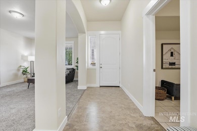 Entryway featuring baseboards and arched walkways