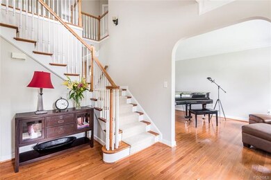 The two-story foyer has hardwood flooring, double 