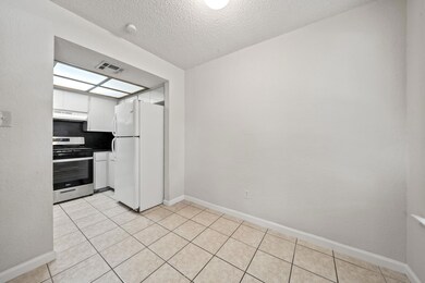 Kitchen with visible vents, freestanding refriger