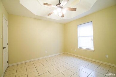 Spare room with ceiling fan and light tile patterned floors