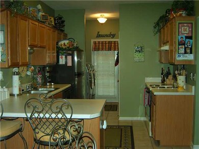 Kitchen has breakfast bar and pantry with tile flo