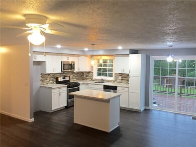 Kitchen with resilient flooring, tile back splash,