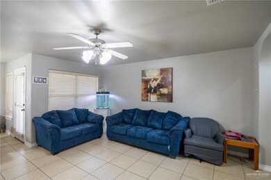 Tiled living room with ceiling fan
