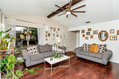 Living area featuring wood finished floors and a ceiling fan