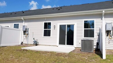 Back of house with a patio, a yard, and central AC