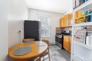 Kitchen featuring appliances with stainless steel finishes, tasteful backsplash, and light countertops