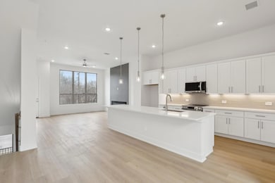 Kitchen with visible vents, light wood-style floor