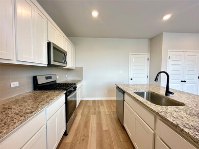 Kitchen featuring appliances with stainless steel