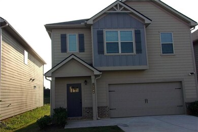Craftsman house with board and batten siding, an attached garage, and concrete driveway