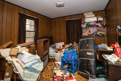 Misc room featuring wooden walls and ornamental molding