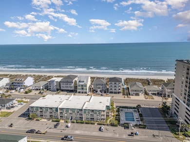 Drone / aerial view with a view of the beach and a water view