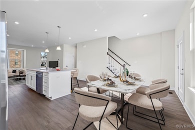Dining area with baseboards, stairs, dark wood fin